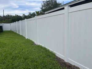 An extended white vinyl privacy fence providing security and aesthetics by Native Outdoors, LLC in Orlando, FL.