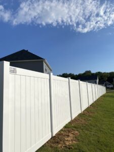 A long, clean white vinyl privacy fence installed by Petty Fence Company LLC, providing services in Evansville, IN.