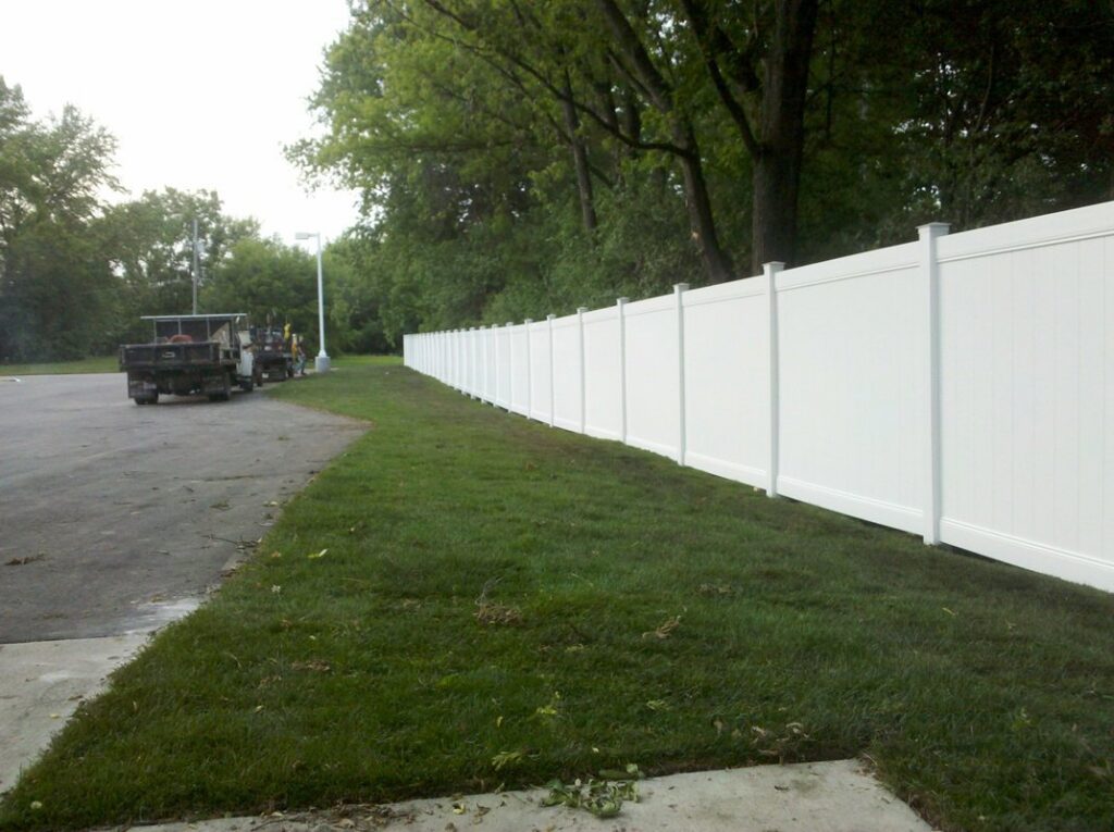 A long white vinyl privacy fence installed by Statewide Fencing, Inc. in Franksville, WI