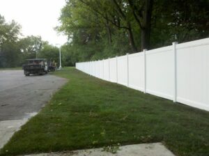 A long white vinyl privacy fence installed by Statewide Fencing, Inc. in Franksville, WI