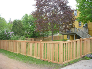 A long wood privacy fence installed along a sidewalk by Melanie K. Lynch in Crawfordville, FL
