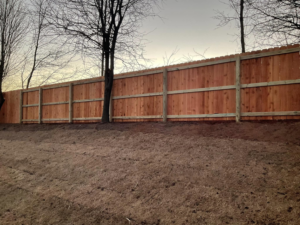 A long section of newly installed wood privacy fence in a residential backyard by Best Fences LLC in Springdale, AR.