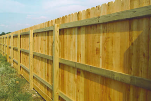A long wooden privacy fence with dog-ear pickets installed by Freedom Fencing of Clarksville, TN.