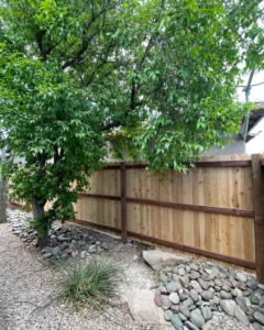 A long section of newly installed wood privacy fence in a backyard by 702 Fence LLC in Las Vegas, NV.