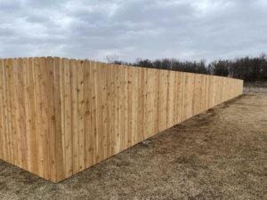 A long, newly installed wood privacy fence completed by Fence Restorations LLC in Ponca City, OK.