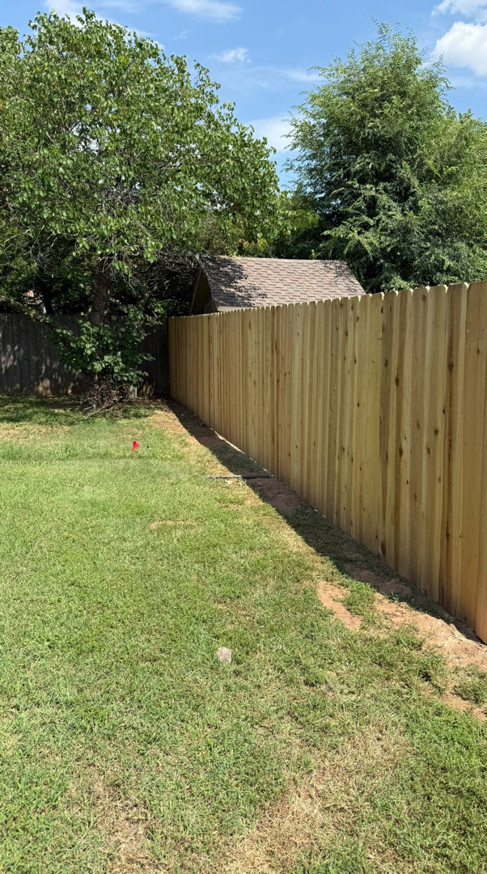 A long section of newly installed wood privacy fence by NC Fencing LLC in Wichita, KS.