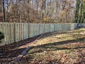 A long stretch of newly installed wood privacy fence by Right Now Fencing, LLC in Johns Creek, GA