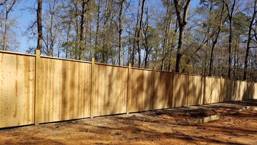 A long stretch of newly installed wood privacy fence by Weber Deck & Fence in Baton Rouge, LA.