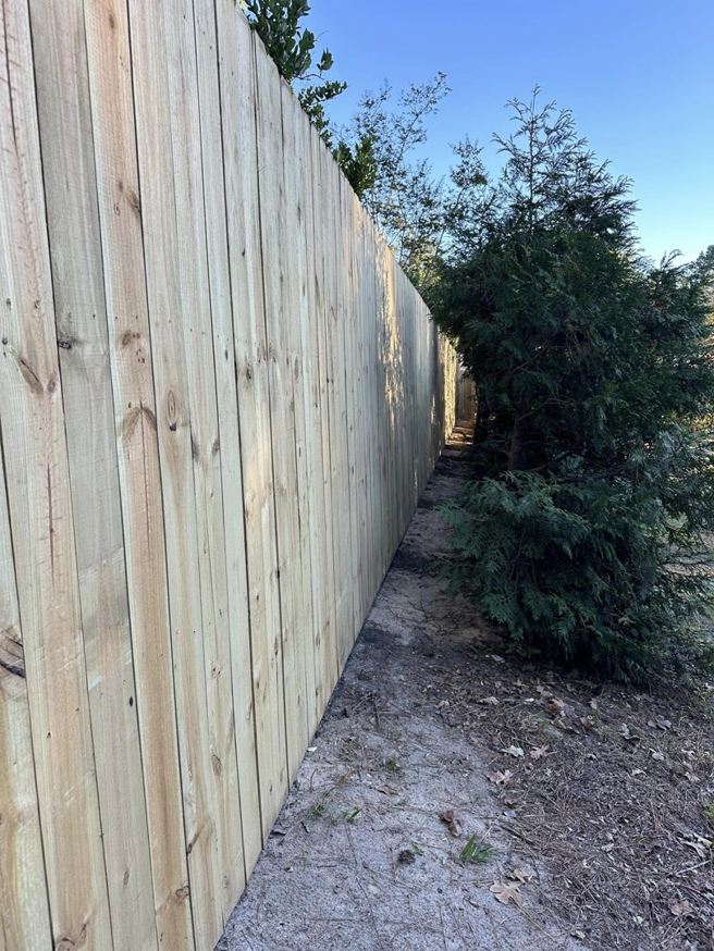 A long line of newly installed wood privacy fence by First in Fencing and Remodeling in Fayetteville, NC.