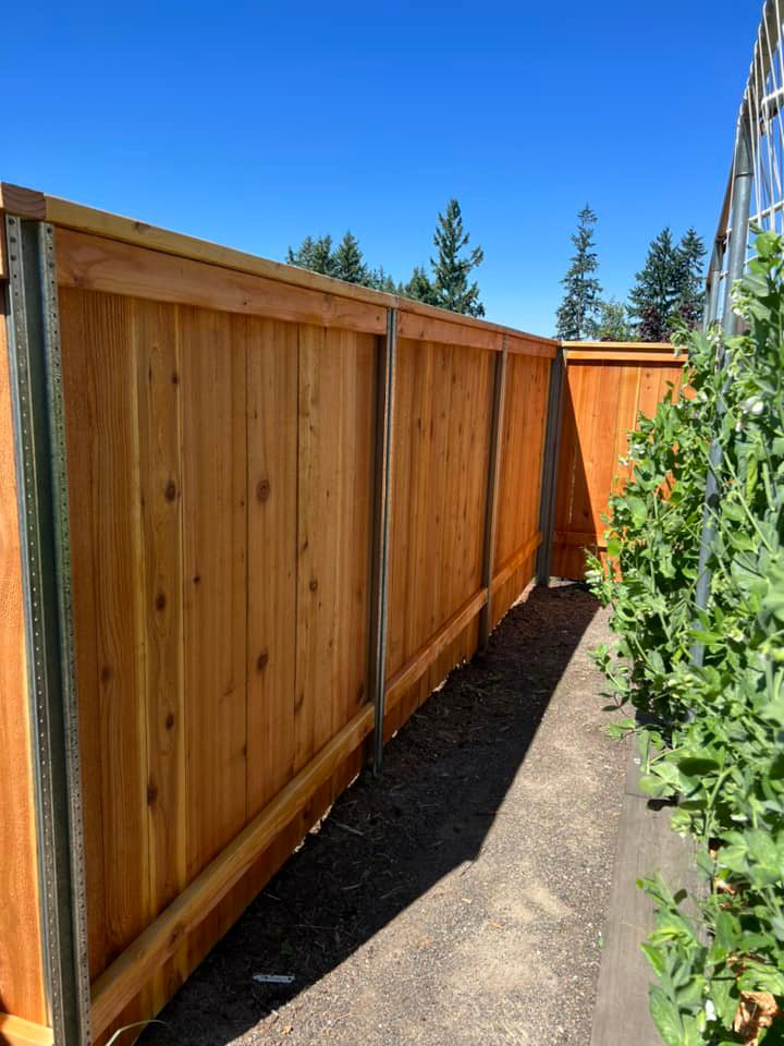A long section of new wood privacy fence installed by RL Quality construction in Gaston, OR.