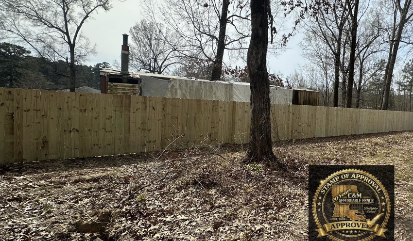 A long section of new wood privacy fence installed by C & M Affordable Fence, LLC in Haughton, LA