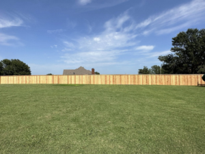 A long wood privacy fence installed for a residential property by DB Construction in Fort Smith, AR.