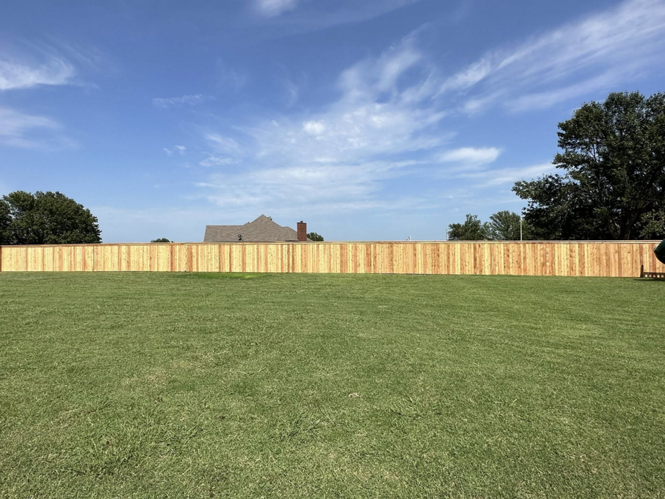 A long wood privacy fence installed for a residential property by DB Construction in Fort Smith, AR.