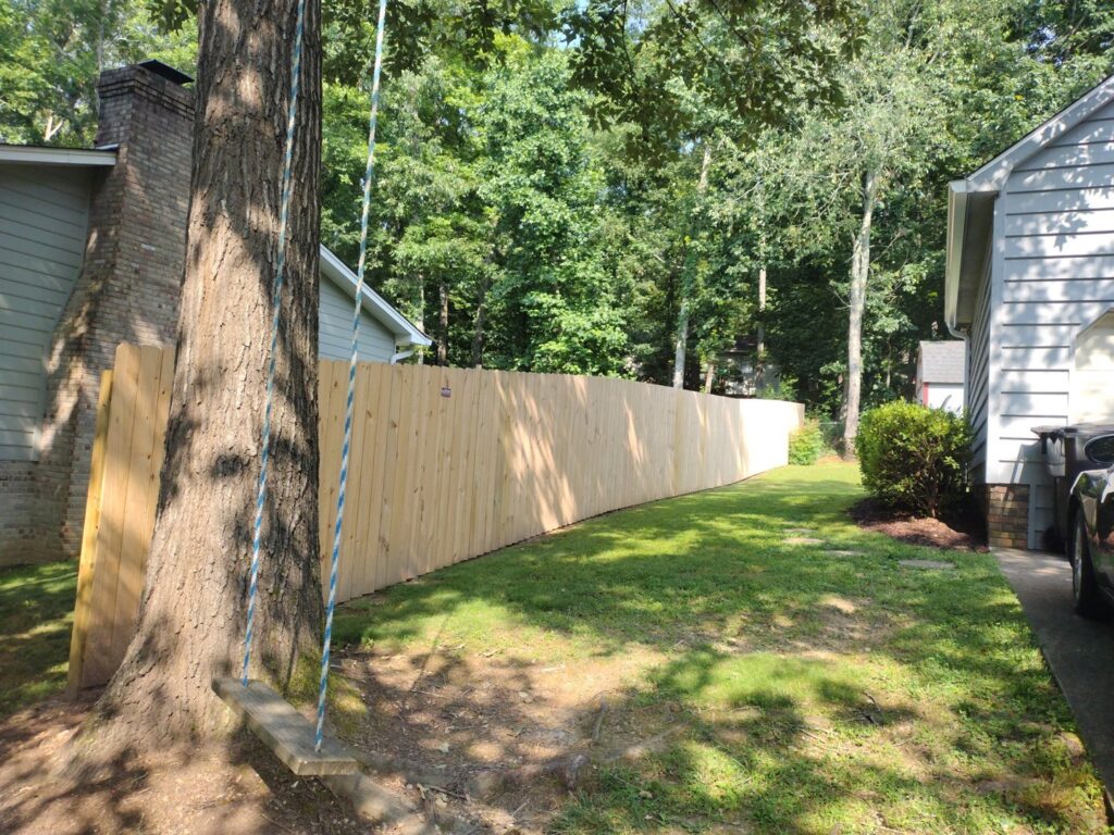 A long wood privacy fence installed next to a residential home by Fantastic Fences in Chattanooga, TN