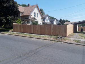 A long, newly installed wooden privacy fence along a street in Spokane, WA, by The Best Fence Company.