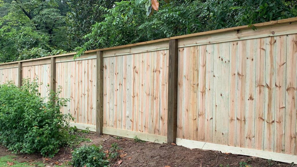 A long, newly installed wood privacy fence by United Fence Company in Johnston, RI.