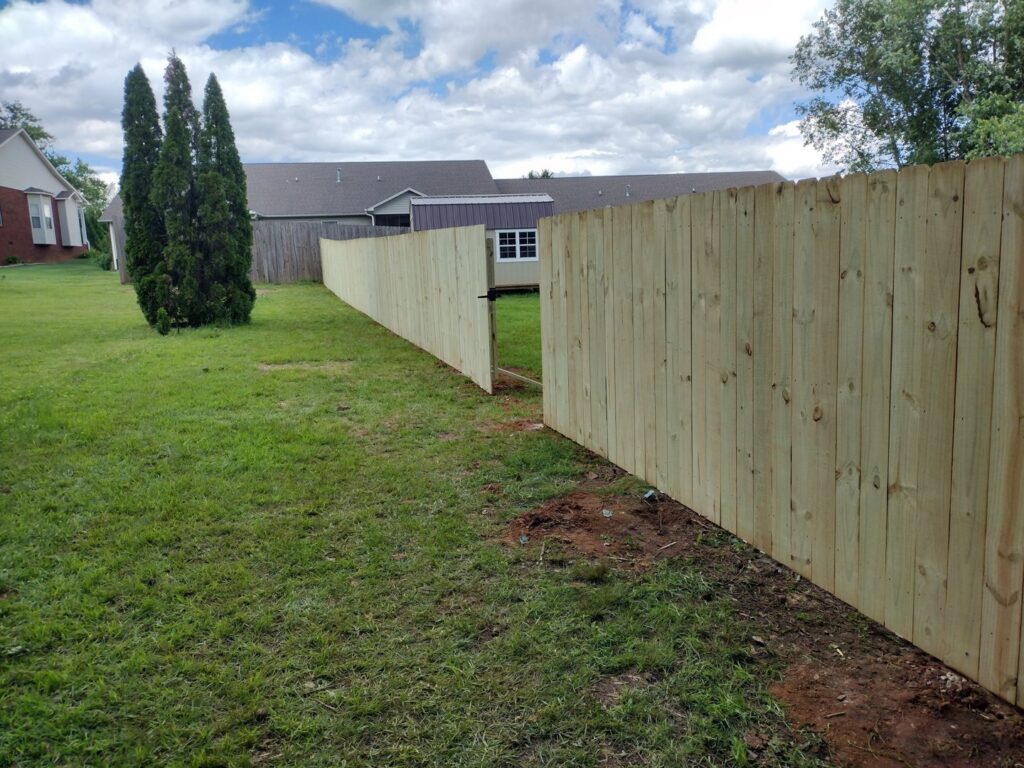 A long wood privacy fence with a gate installed by Fantastic Fences in Chattanooga, TN