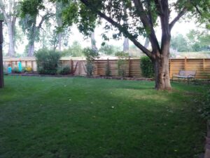 An extensive wooden split-rail fence with wire mesh, ideal for large properties, installed by Best Boy's Fencing in Fort Collins, CO.