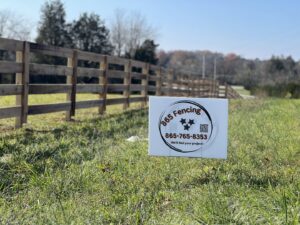 A long wooden farm fence installation stretching across a field, completed by 865 Fencing in Knoxville, TN.