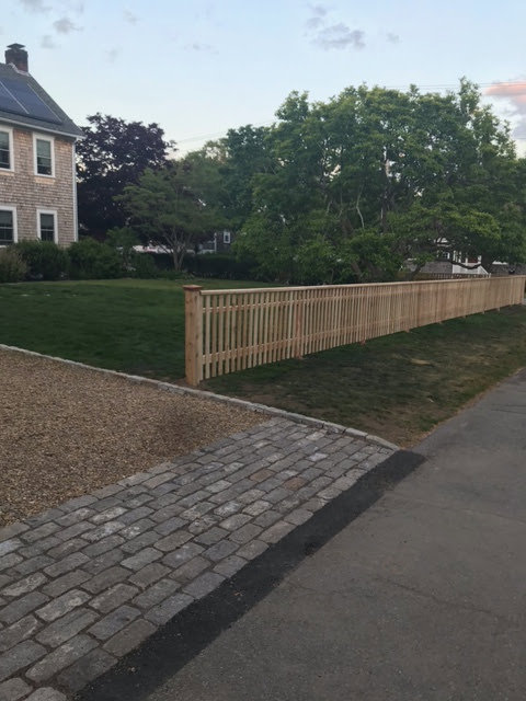 A long wooden picket fence installed along a residential street by Profence in Leander, TX.