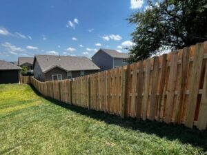 A long line of wooden picket fencing installed by Custom Vinyl Fabrication in Omaha, NE.