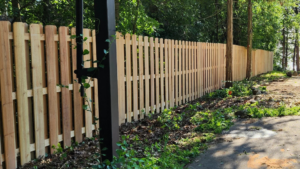 A long wooden picket fence installed along a residential property by Browning & Sons Fencing, Home Renovations, and More in Suwanee, GA.