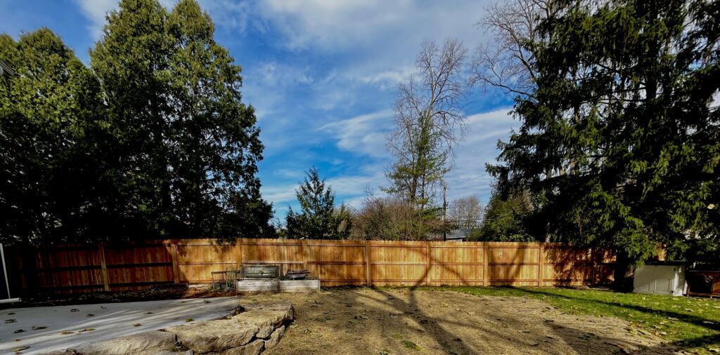 An extensive wooden privacy fence installed around a residential backyard by Brothers Fence Co. in Madison, WI.