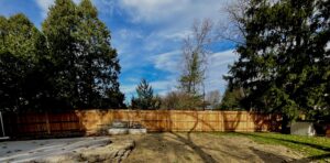 An extensive wooden privacy fence installed around a residential backyard by Brothers Fence Co. in Madison, WI.