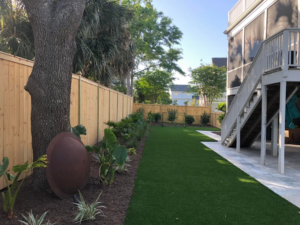 A long wooden privacy fence extending along a residential backyard installed by Lowcountry Home Works843 LLC in Summerville, SC.
