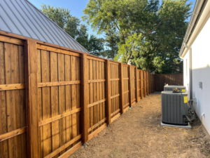A long section of newly installed wooden privacy fence alongside a residential property by 3M Custom Fence in Lewisville, TX.