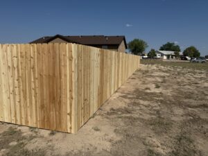 A long wooden privacy fence installation by Pueblo Fence Co in Pueblo West, CO.