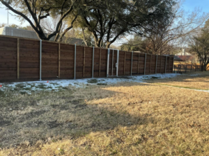 A long, newly installed wooden privacy fence line by B & S Fence Company, serving Haltom City, TX