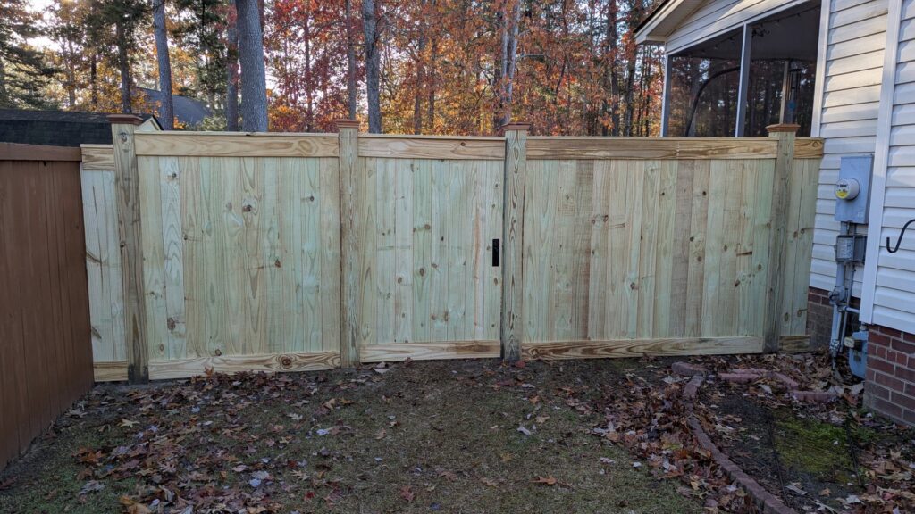 A long, newly installed wooden privacy fence for a residential property by Gifford Contracting & Repair in Goose Creek, SC.