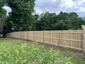 Long wooden privacy fence installed along a residential property by Select Fence & Guardrail in North Haven, CT.