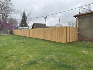 A long wooden privacy fence providing seclusion for a residential yard, installed by Thrive Fencing in Ames, IA.