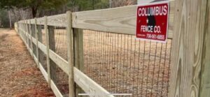 A long wooden fence with wire mesh, installed by The Columbus Fencing Company in Columbus, GA.