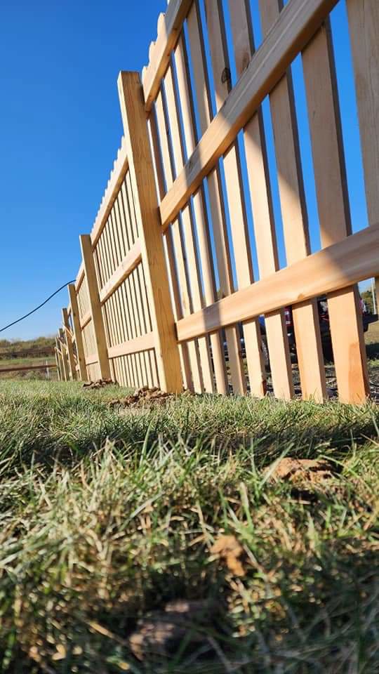 A low-angle view of a newly installed wood fence, showcasing quality craftsmanship by Hotshot Fencing and Gates in Kansas City, MO.