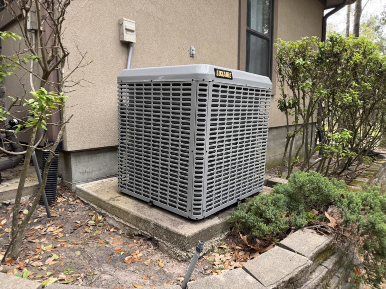A newly installed Luxaire HVAC condenser unit outside a residential home by ProTexAir HVAC Services in Houston, TX.
