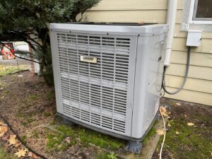 A Luxaire outdoor HVAC unit installed next to a residential building by Gresham Heating and Air Conditioning in Wood Village, OR.