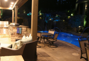 A luxurious backyard with a custom pool, spa, and outdoor kitchen built by Anderson Poolworks in Wilsonville, OR.