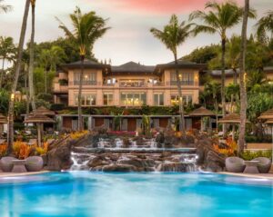 A luxurious resort-style pool with multiple waterfalls and tropical landscaping, a project by Anderson Poolworks in Wilsonville, OR.