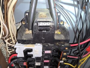 A close-up view of a main electrical breaker panel with a 200 amp main switch by Be Bright Electric in Erie, PA.
