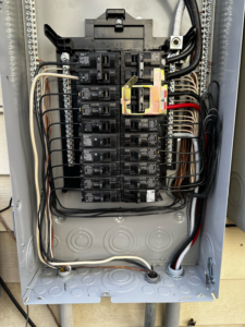 An open main electrical breaker panel with organized wiring by J. K. Quality Electric in Saint Bernard, LA.