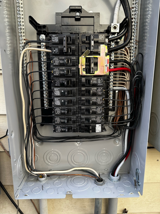 An open main electrical breaker panel with organized wiring by J. K. Quality Electric in Saint Bernard, LA.