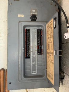 A main electrical disconnect panel with an open breaker box, installed by Mayflower Electric LLC in Knoxville, TN
