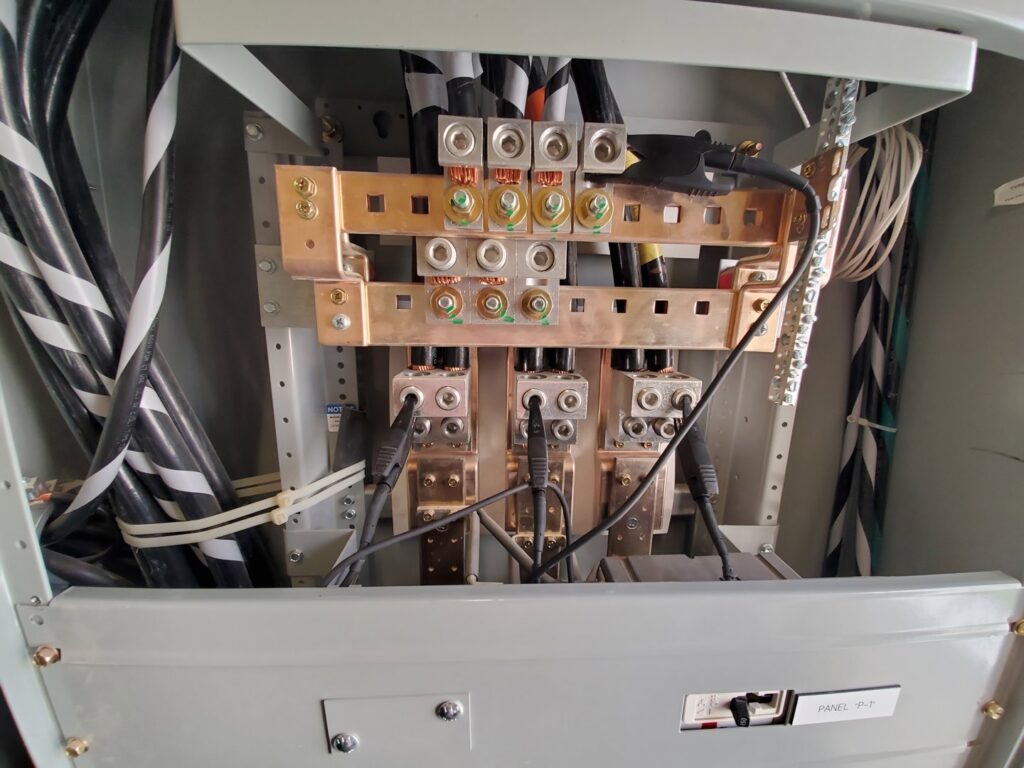 A main electrical panel with busbars and heavy-duty cables installed by Allied Electric in Sparks, NV.
