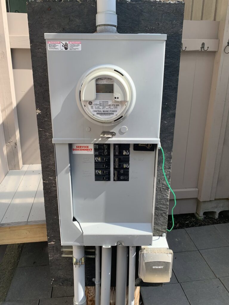 A main electrical service disconnect and meter installation on a home's exterior by Building Connections LLC in Auburn, ME.