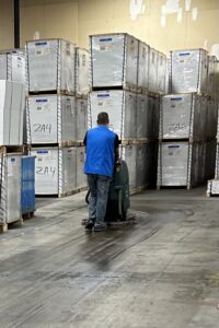 A man from 2themax Services LLC cleaning an event space carpet with a machine in Carmel, IN.