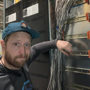 A man working on an electrical panel with numerous wires at MDMartin Electrical LLC in Philadelphia, PA.
