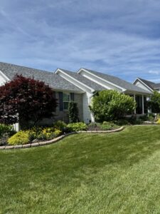 A beautifully manicured front yard with lush green grass and well-maintained landscaping by Ryan's Lawn Service, LLC in Charlotte, NC.